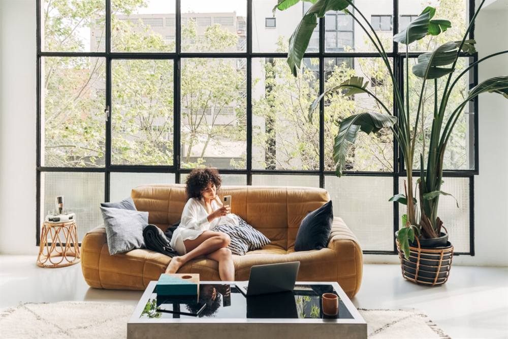 A woman resting on a couch at home